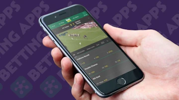 Reviewer holding an iphone displaying a screenshot of bet365 live streaming football
