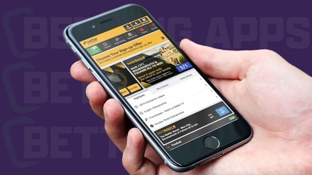 Reviewer holding smartphone with Betfair app displaying Premier League offer
