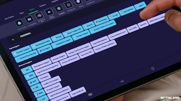 Someone browsing football leagues on the Grosvenor Sport app with an i Pad