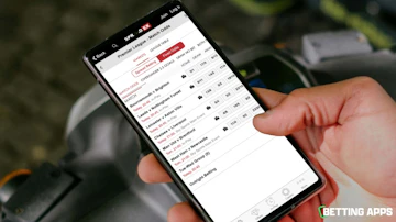 Someone browsing todays premier league matches on the Spreadex app