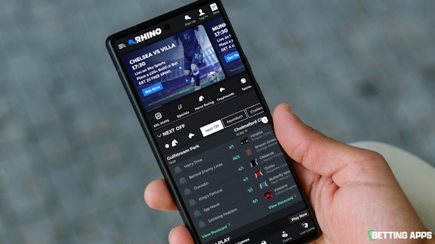 Someone holding a phone showing the Rhino Bet home screen