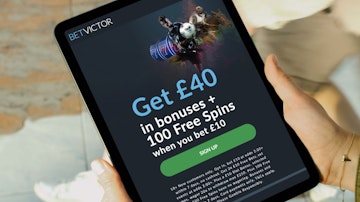 Someone holding an ipad showing the Bet Victor welcome offer