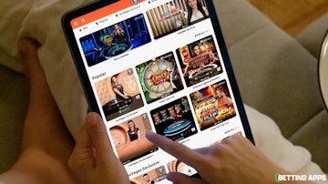 Someone using an ipad to look through the Leo Vegas casino section