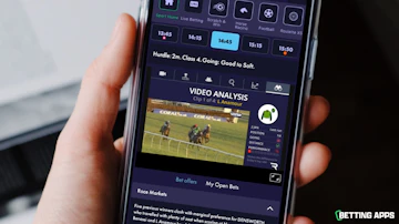 Somone holding an i Phone and looking at the race analysis on the Grosvenor Sport app